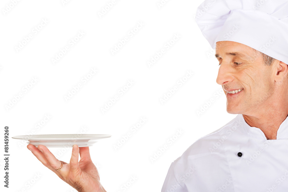 Chef holding white porcelain plate Chef holding white porcelain plate