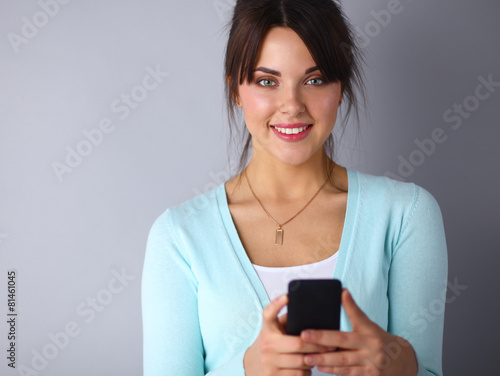 Woman using and reading a smart phone