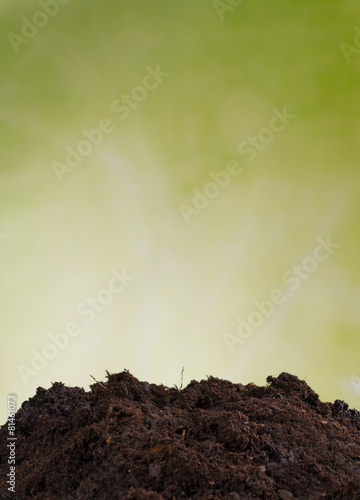 Pile of soil with green background