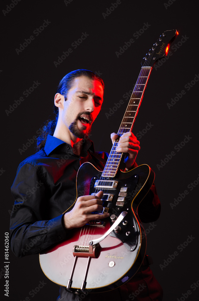 Fototapeta premium Man with guitar during concert