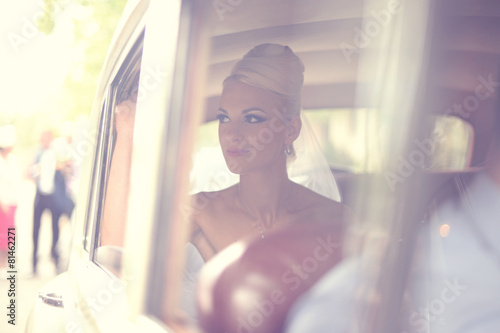 Beautiful bride waiting in the car