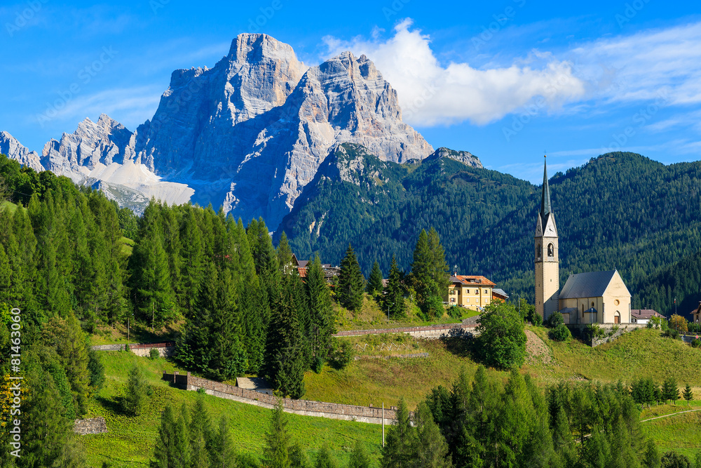View of Pian village with church in Dolomites Mountains, Italy