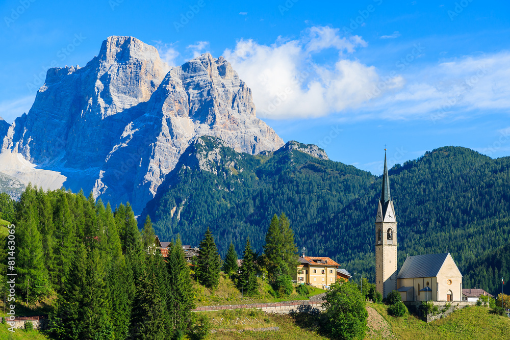 View of Pian village with church in Dolomites Mountains, Italy