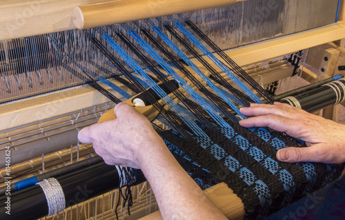 Woman Weaving Using a Boat Shuttle