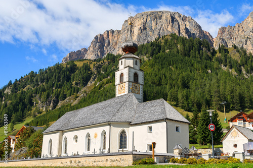 Church in Colfosco alpine village, Dolomites Mountains, Italy