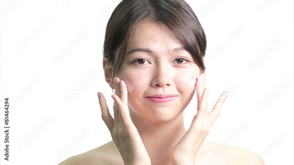 Chinese Woman Applying Cream to Face with Hands, Medium Close Up Chinese Woman Applying Cream to Face with Hands, Medium Close Up