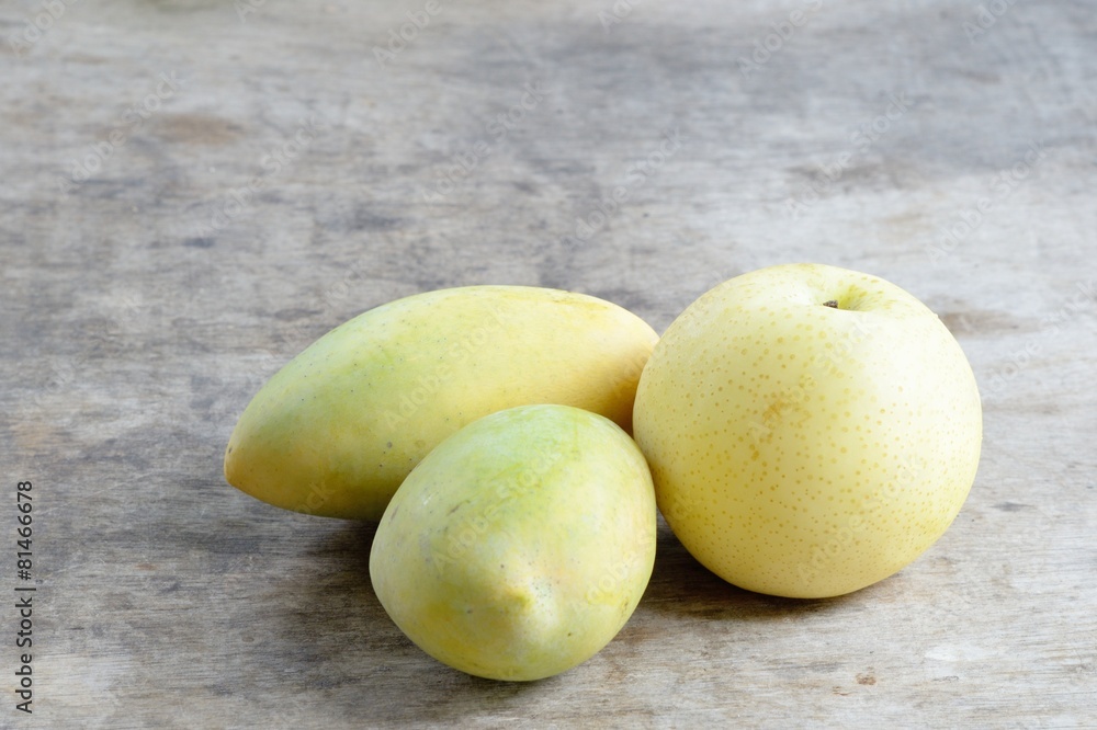 Chinese pear and Ripe Mangoes on wooden background Chinese pear and Ripe Mangoes on wooden background