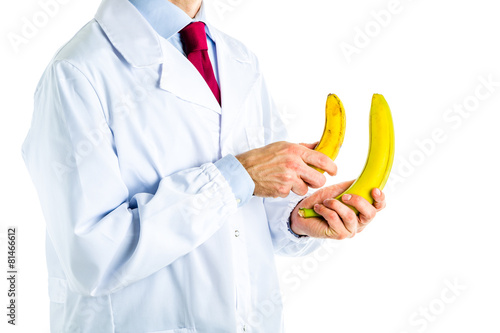 Doctor in white coat showing big and small bananas