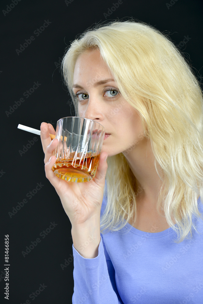 Blond woman drinking and smoking Blond woman drinking and smoking