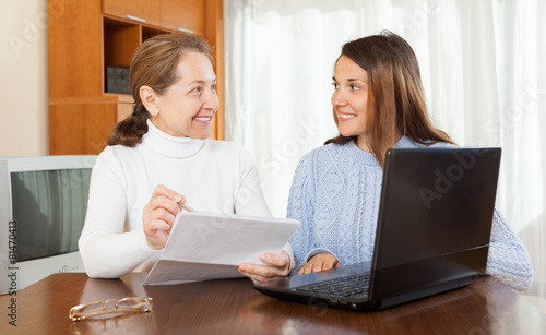 Woman and daughter with laptop