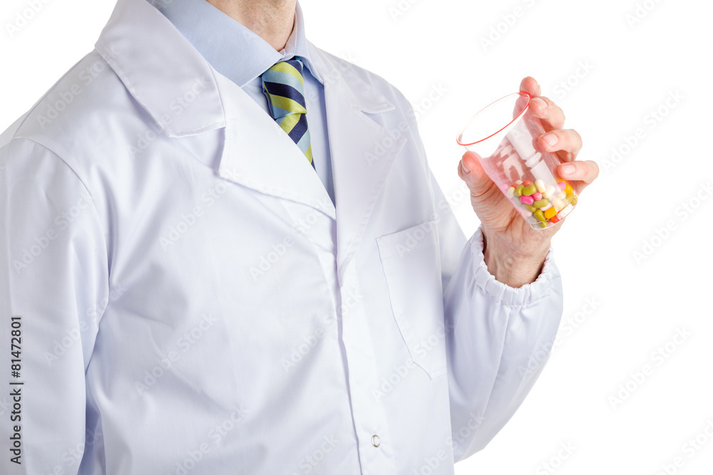 Man in medical coat holding plastic glass with pills Man in medical coat holding plastic glass with pills