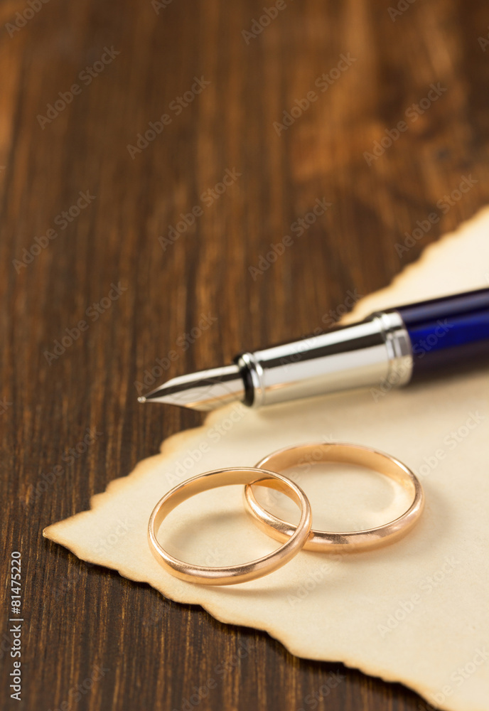 wedding ring and aged paper on wood wedding ring and aged paper on wood