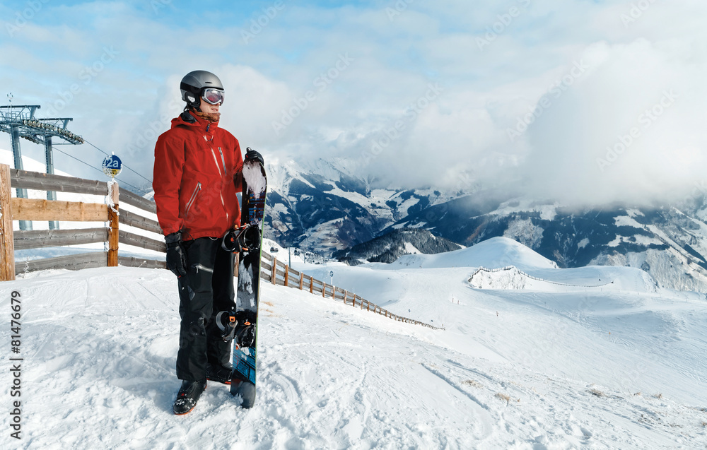 Male snowboarder against winter mountains background Male snowboarder against winter mountains background