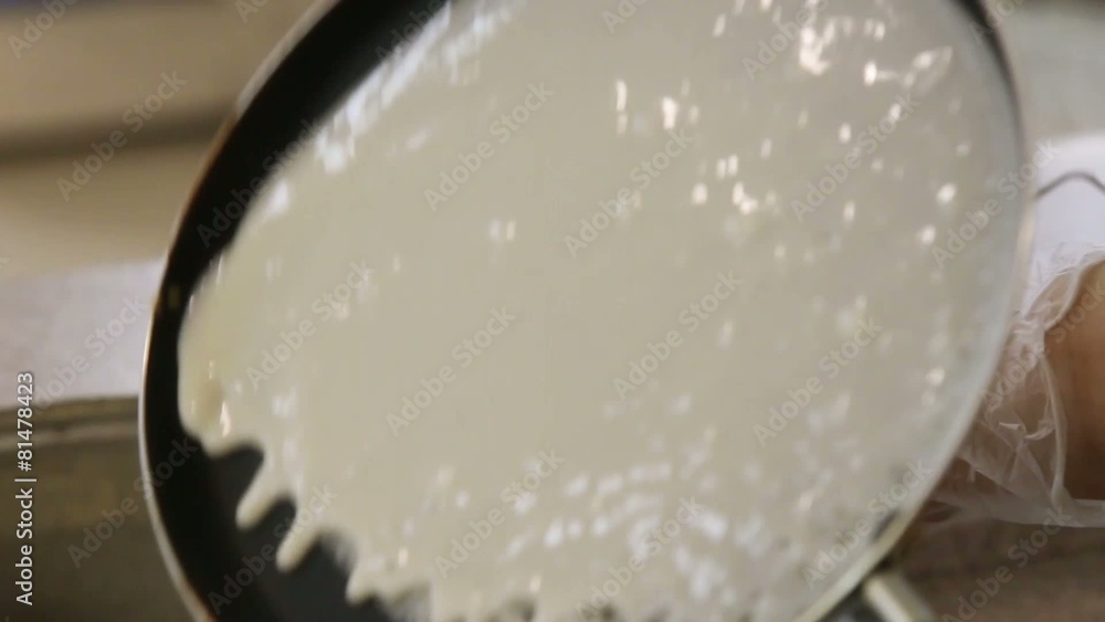 pouring dough in pan cooking pancake from the ladle pouring dough in pan cooking pancake from the ladle