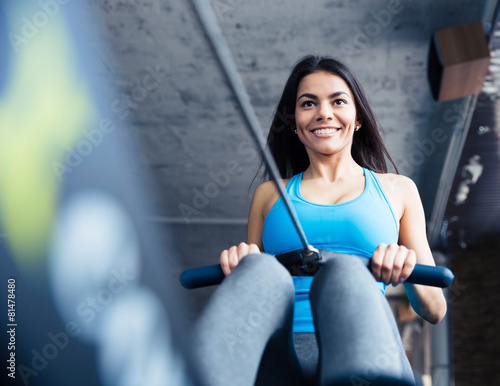 Happy charming woman working out at gym photo