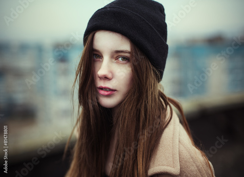 portrait of a beautiful girl on the roof of a hipster.