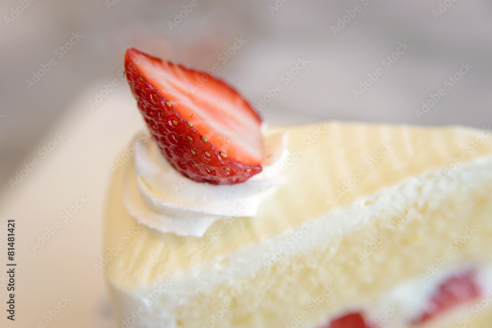 Close up to strawberry on piece of strawberry cake Close up to strawberry on piece of strawberry cake