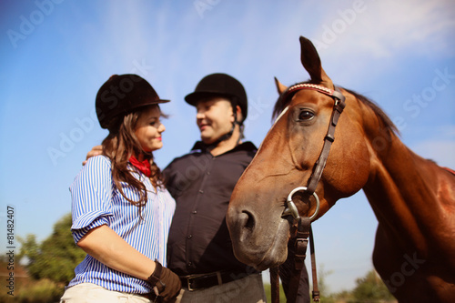 Couple playing with a horse