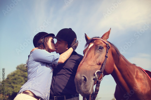 Couple playing with a horse