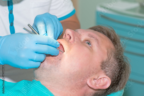 man in dentist office doing annual check up