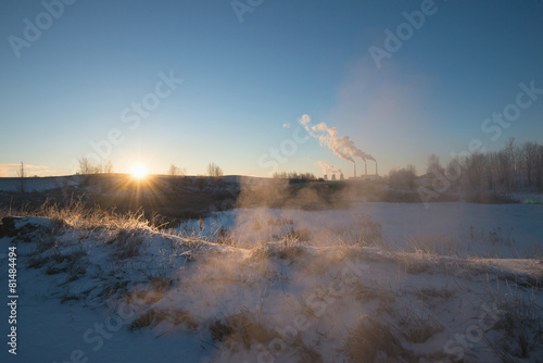Winter landscape with factory chimneys