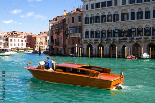 A specific water taxi on The Grand Canal in Venice. The canals s