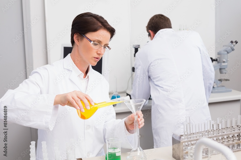 Scientists working attentively with test tube and computer Scientists working attentively with test tube and computer