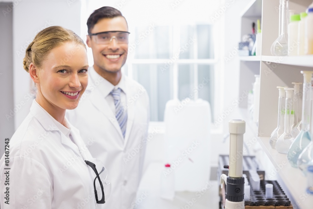 Smiling scientists looking at camera Smiling scientists looking at camera