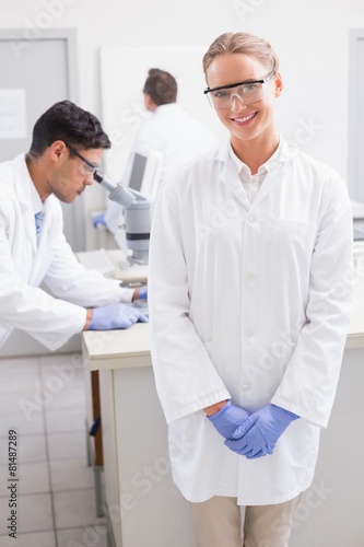 Smiling scientist looking at camera