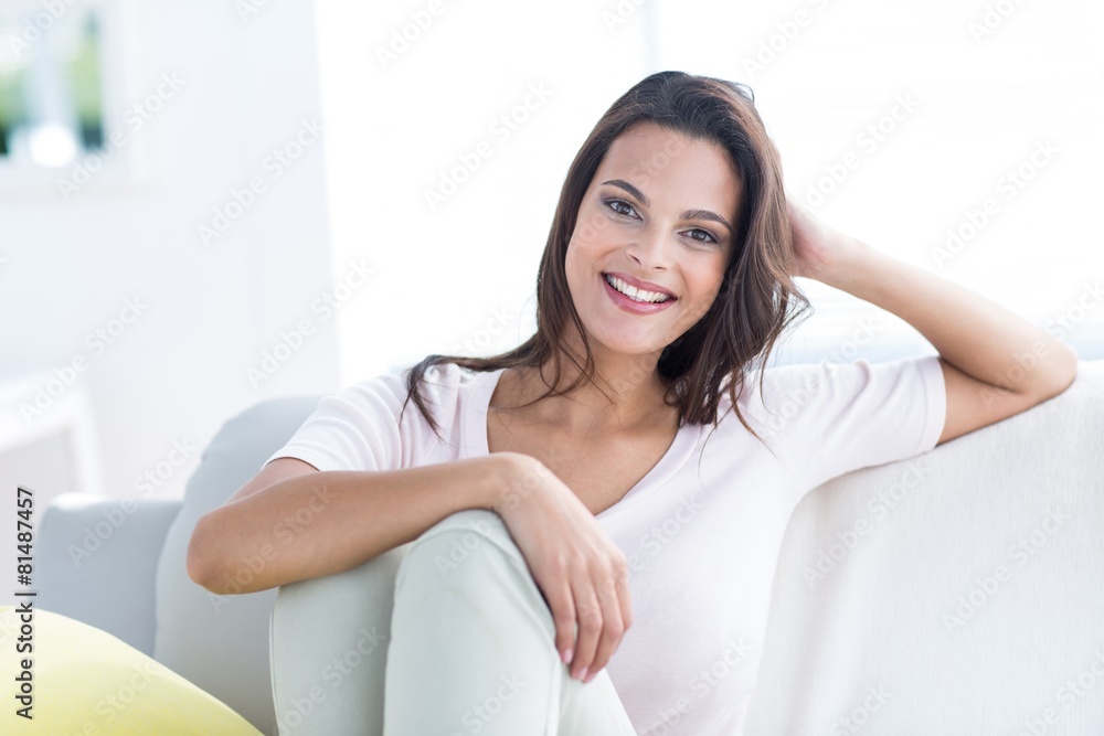 Smiling beautiful brunette relaxing on the couch Smiling beautiful brunette relaxing on the couch