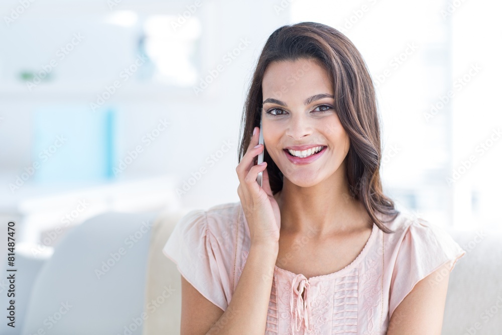 Smiling beautiful brunette speaking on the phone Smiling beautiful brunette speaking on the phone