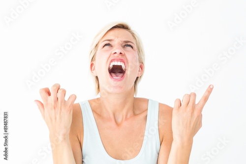 Upset woman screaming with hands up