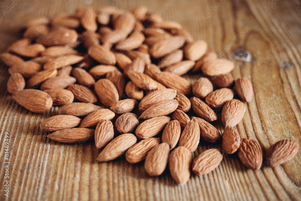 almonds on wooden surface almonds on wooden surface