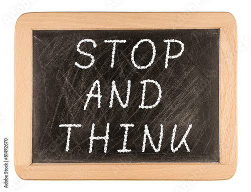 The phrase Stop and Think written on a blackboard as a reminder photo