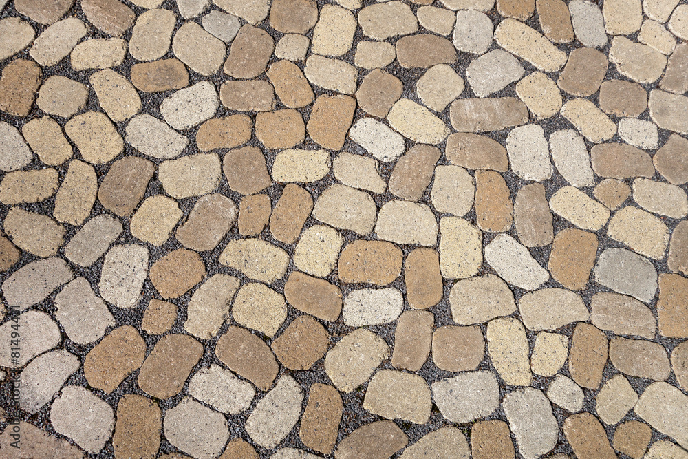 Mosaik aus ovalen grauen und braunen Pflastersteinen Mosaik aus ovalen grauen und braunen Pflastersteinen