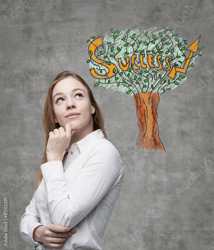 Slika na platnu Young business woman is thinking of success way.