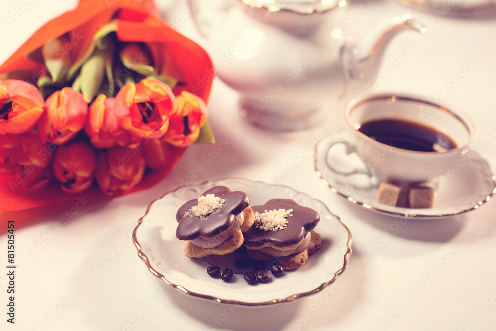 Delicious cake with coffe and tulips on table Delicious cake with coffe and tulips on table