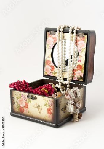 Wooden casket with jewellery on white background