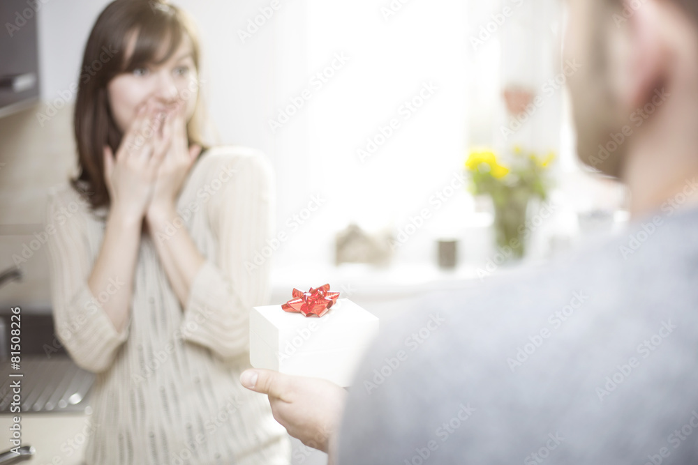 Man giving woman gift for her birthday
