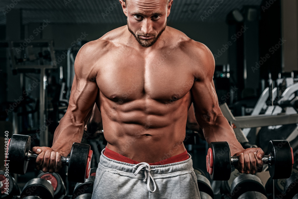 Muscular man doing a exercise for biceps Muscular man doing a exercise for biceps
