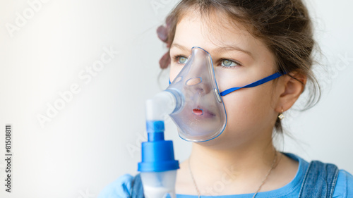 girl with asthma / allergy inhaler - inhalation mask