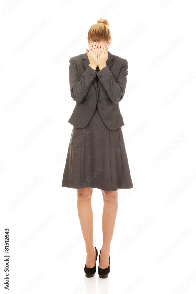 Businesswoman covering face with hands. Businesswoman covering face with hands.