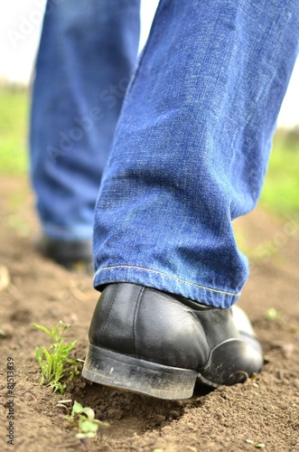 Male feet walking on the soil