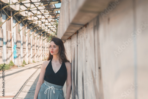 Beautiful brunette posing in an industrial context