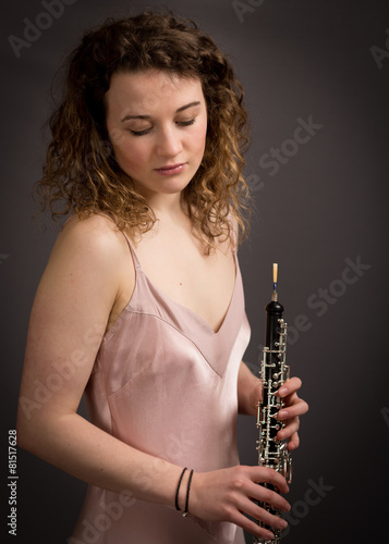 Beautiful Young Female Oeboist In Pink Dress photo