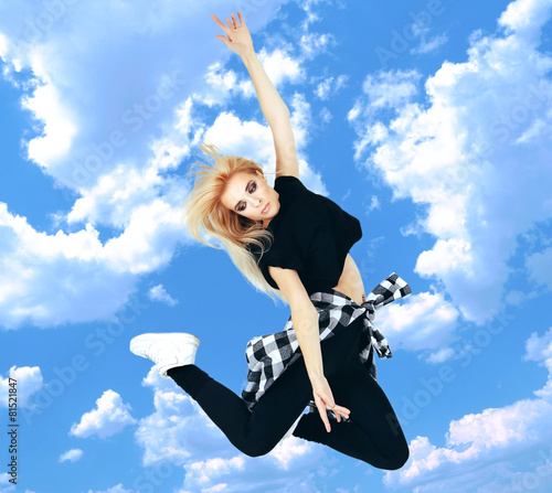 Jumping woman on sky backgr...