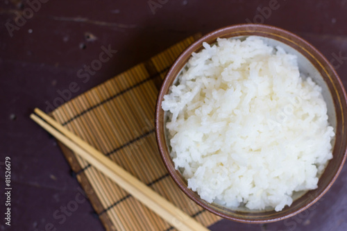 Steamed rice in a bowl and chopstick