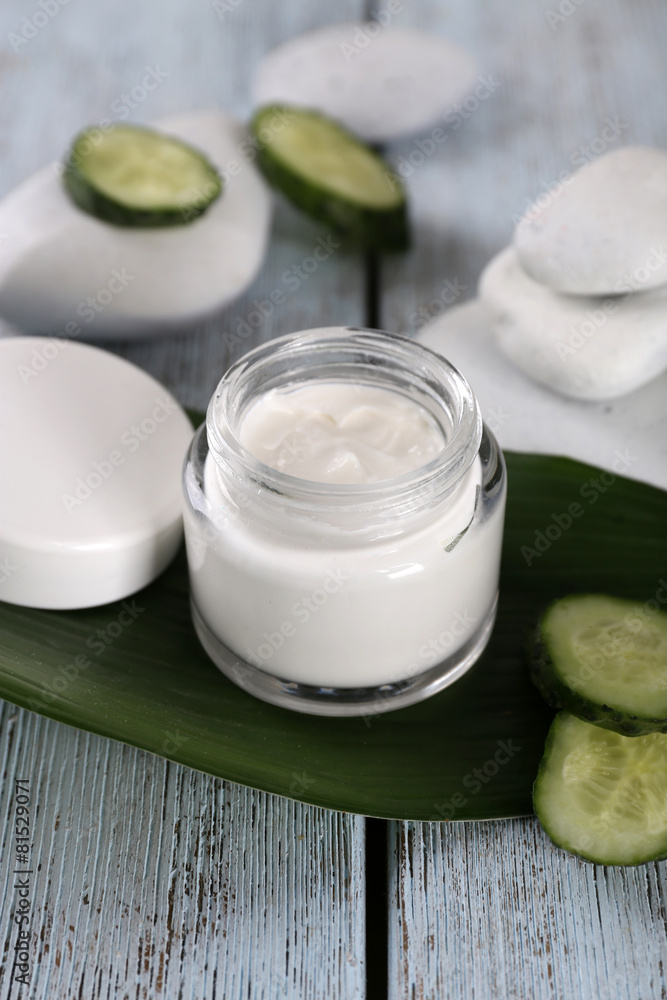 Cosmetic cream with slices of cucumber and spa stones Cosmetic cream with slices of cucumber and spa stones