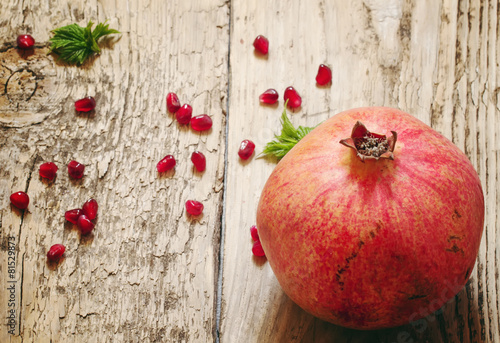 pomegranate with seeds and leaves photo