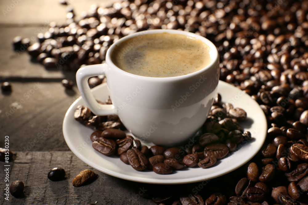 Cup of coffee with grains, closeup Cup of coffee with grains, closeup